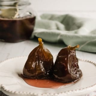 Figs in Syrup with a jar at the back and a green table cloth