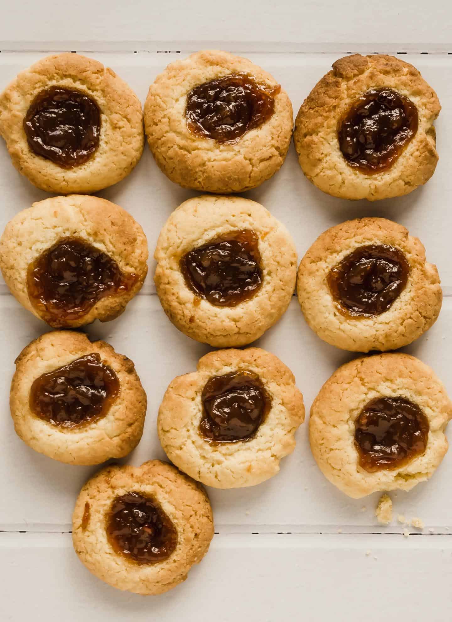 Quince Thumbprint Cookies laid in order on the countertop