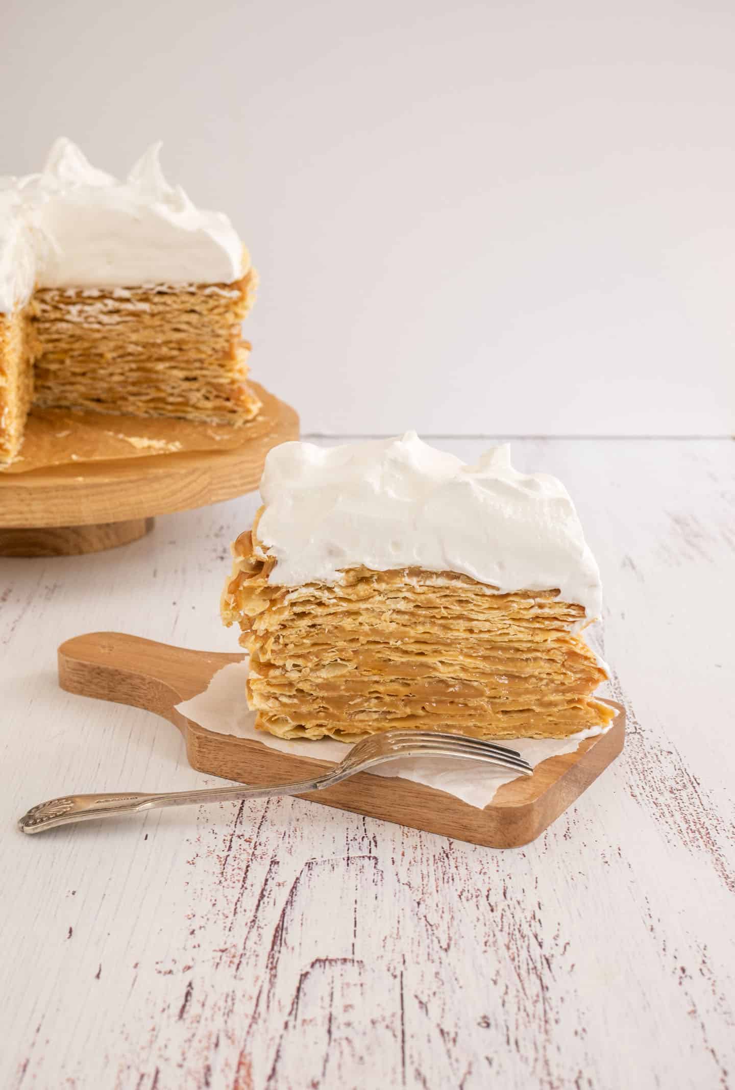 Slice of this dessert with lots of dulce de leche and Swiss meringue