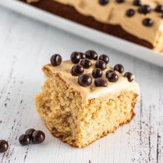 Slice of banana sheet cake with chocolate-covered blueberries