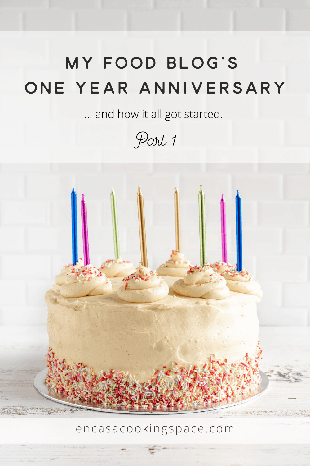 En Casa Blog's One year Anniversary, with a vanilla cake in the background, with colored candles