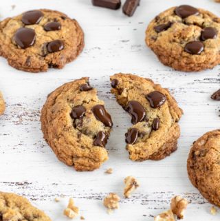 Close shot of the Walnuts and Choc Chunks Cookies on a white background A cookie cut in half
