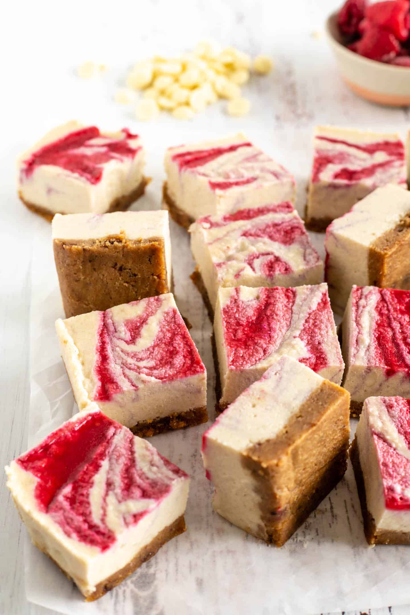 Raspberry and white chocolate bars on a white surface